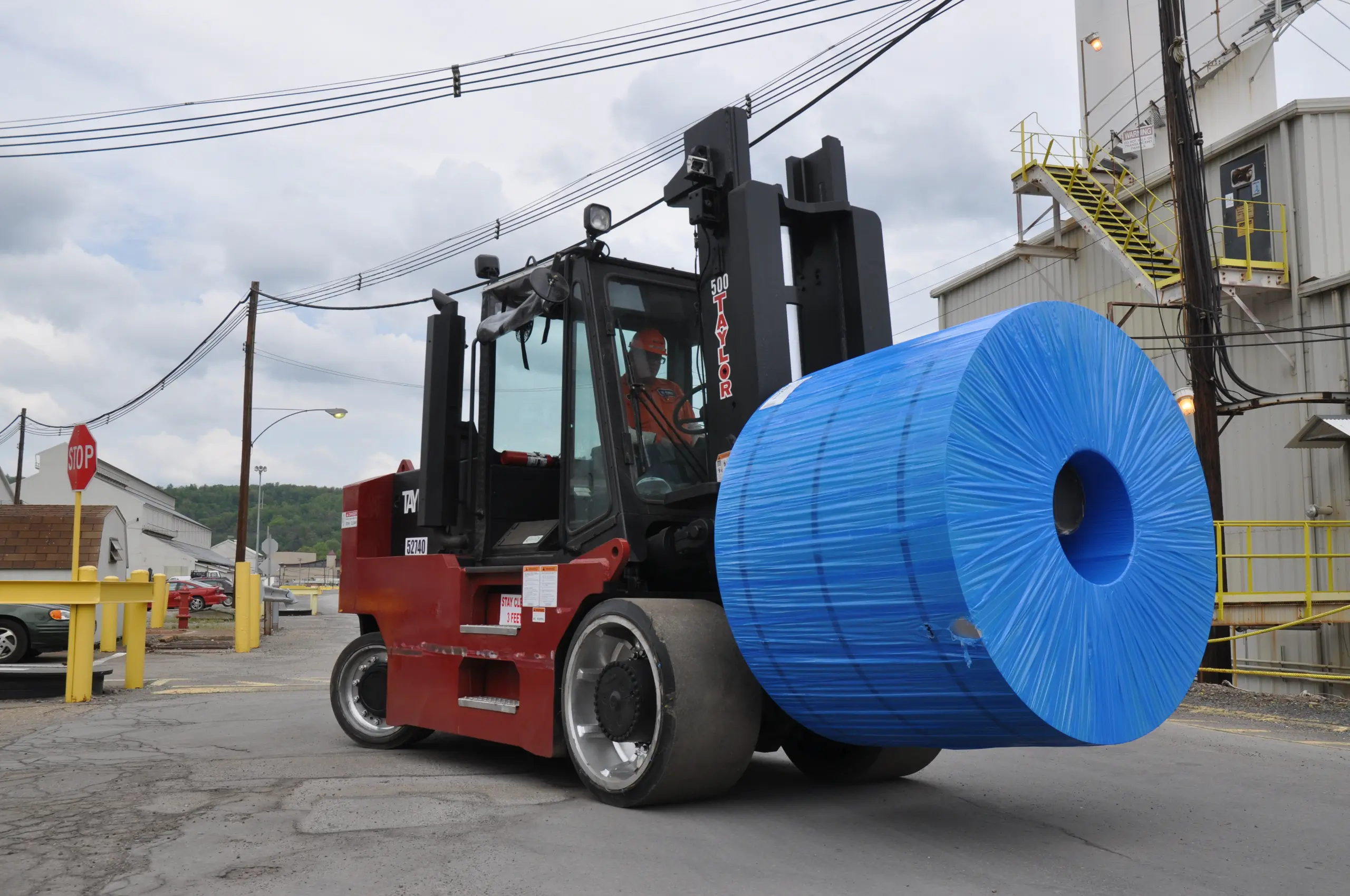 Taylor cushion tire forklift with roll clamp in mill