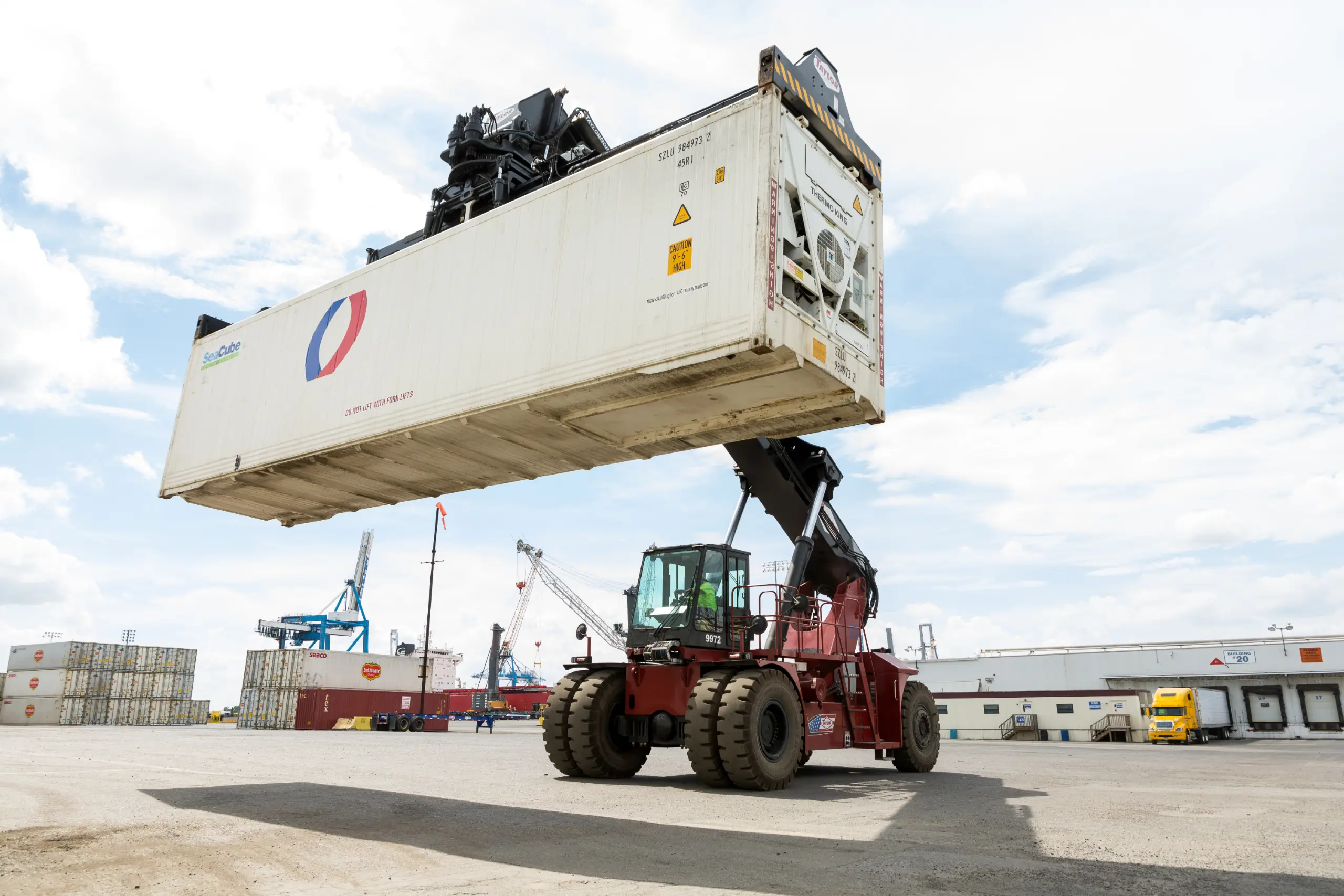 Taylor reach stacker lifting container in rail yard