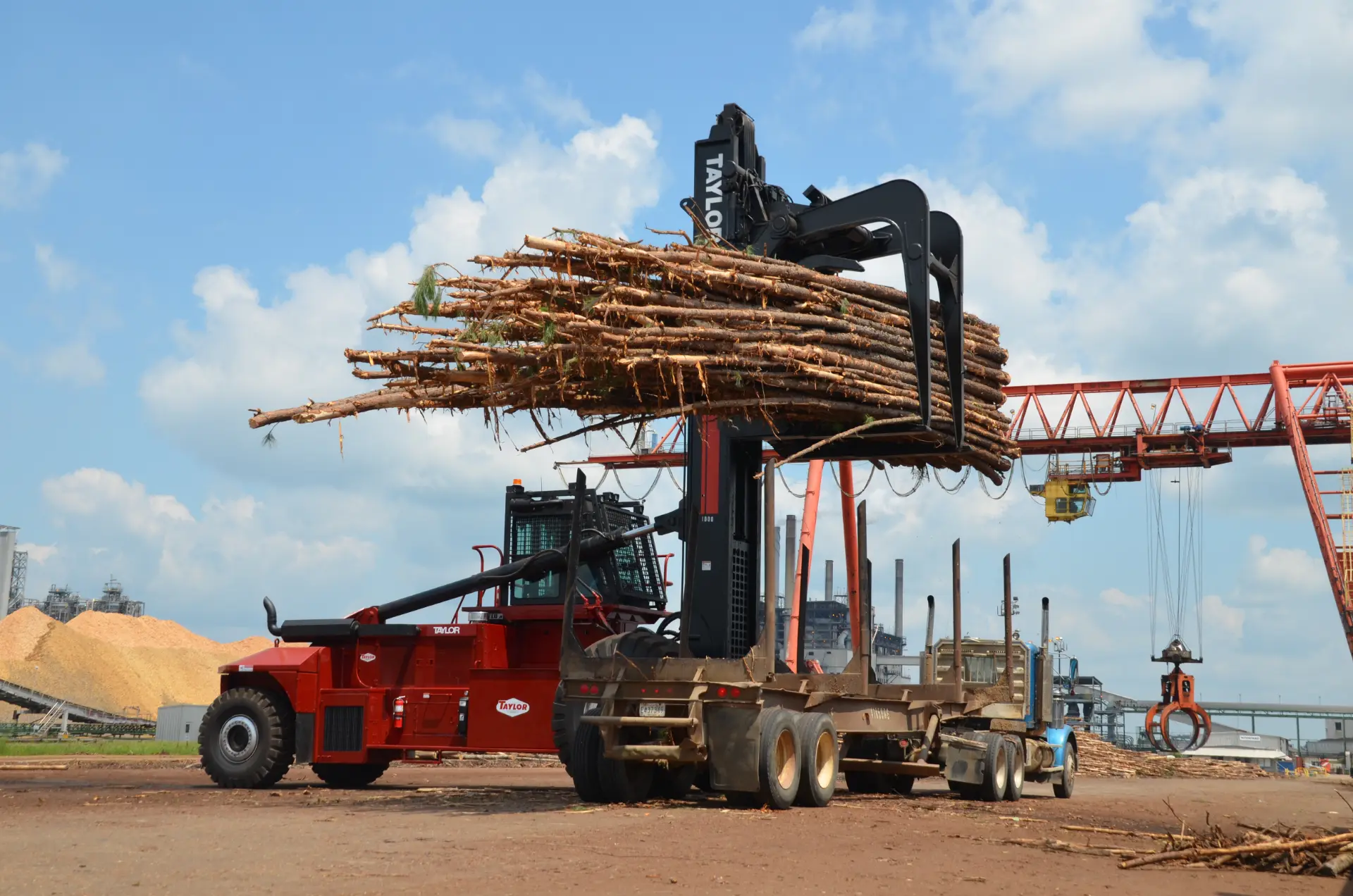 Taylor logstacker unloading 18 wheeler logs