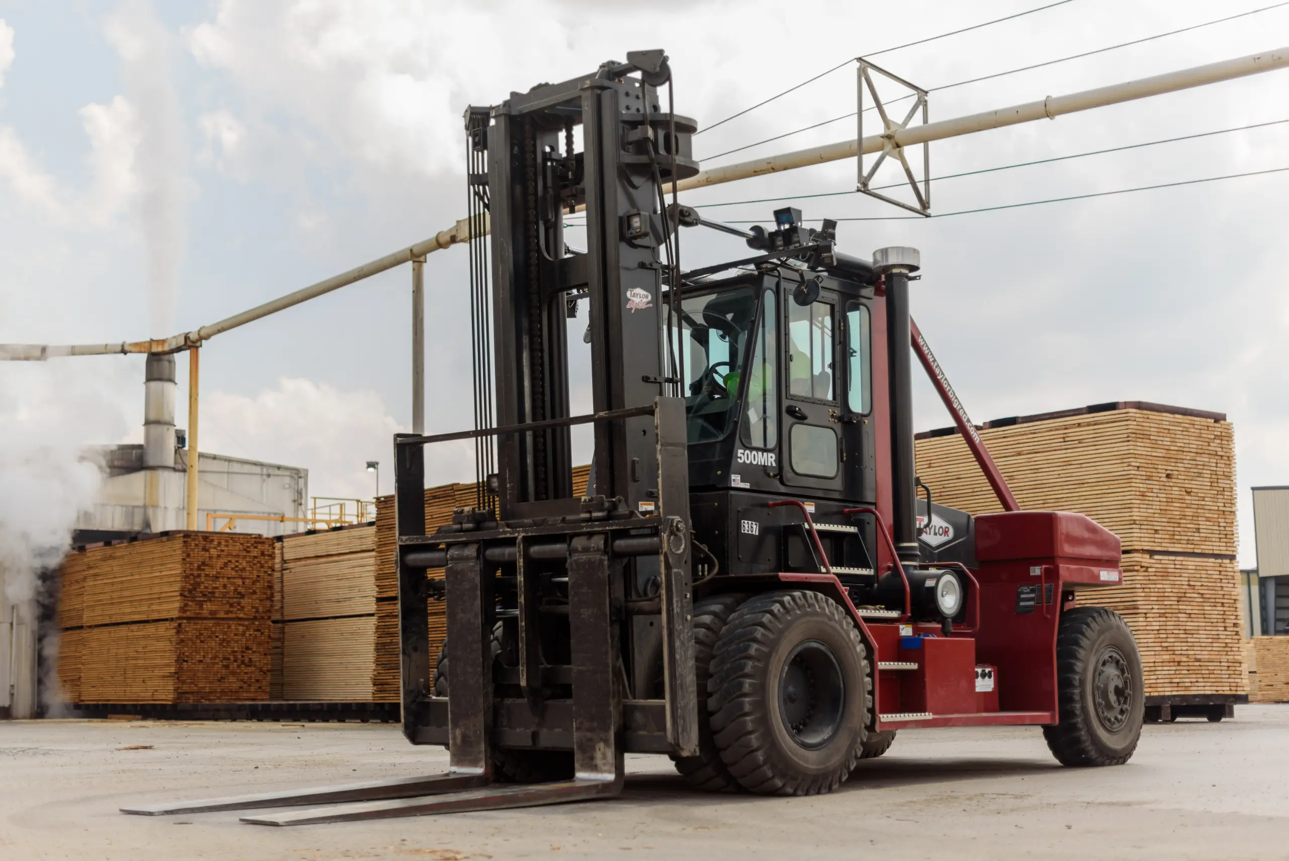 Taylor X550MR raised cab forklift at lumber mill